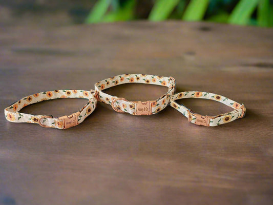 Set of three Honey's Flowers Collars by Honey & Co in different sizes, showcasing a sunflower floral design and rose gold hardware.